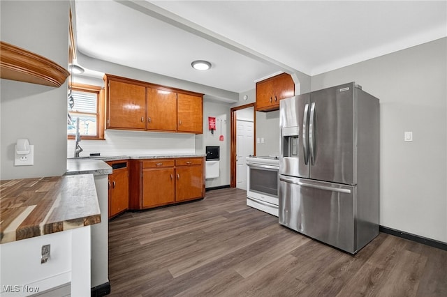 5077 Catherine St, Maple Heights, OH 44137 - kitchen featuring stainless steel fridge with ice dispenser, white electric range oven, dark wood-type flooring, and brown cabinetry