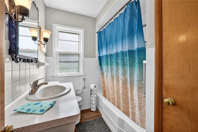 5077 Catherine St, Maple Heights, OH 44137 - bathroom with tile walls, shower / bath combination with curtain, vanity, and a wainscoted wall