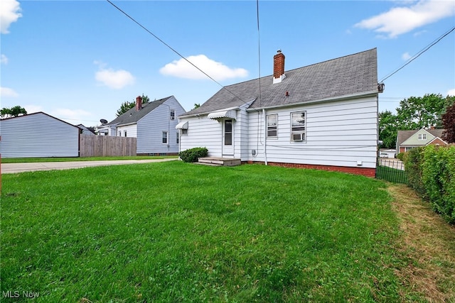 5077 Catherine St, Maple Heights, OH 44137 - back of house with a chimney and roof with shingles