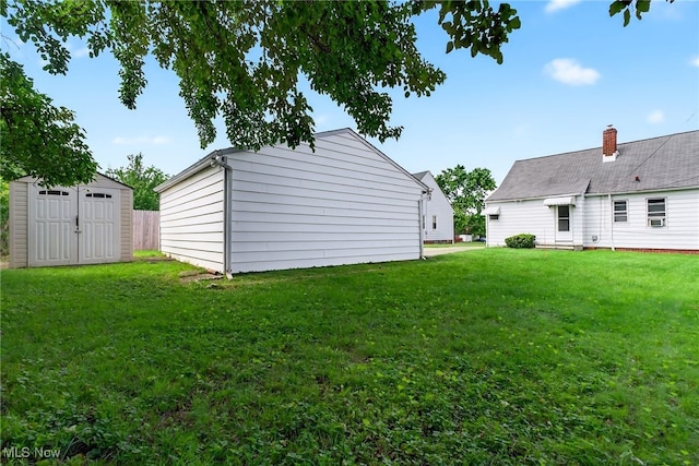 5077 Catherine St, Maple Heights, OH 44137 - view of grassy yard featuring a storage shed