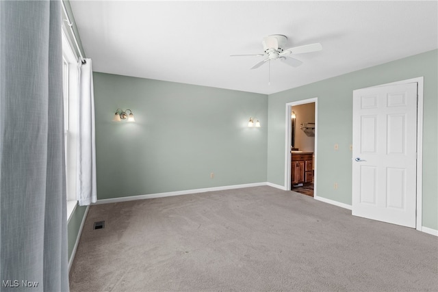 5215 River Rd, Madison, OH 44057 - unfurnished bedroom featuring carpet flooring, connected bathroom, and a ceiling fan