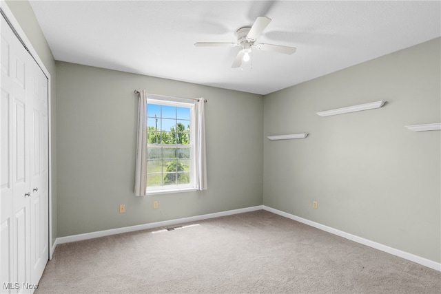 5215 River Rd, Madison, OH 44057 - unfurnished bedroom featuring a closet, carpet, and ceiling fan