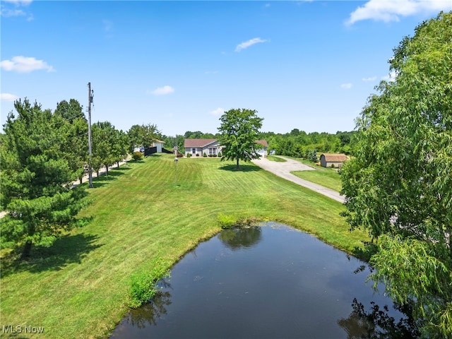 5215 River Rd, Madison, OH 44057 - surrounding community with a water view and a lawn