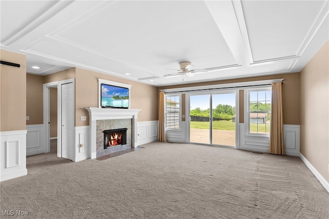 5215 River Rd, Madison, OH 44057 - unfurnished living room with carpet flooring, a wainscoted wall, a tile fireplace, a ceiling fan, and recessed lighting