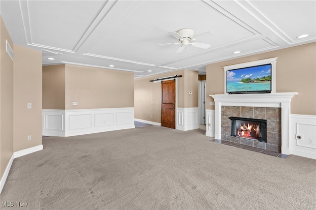5215 River Rd, Madison, OH 44057 - unfurnished living room with a ceiling fan, carpet flooring, recessed lighting, a barn door, and a tiled fireplace