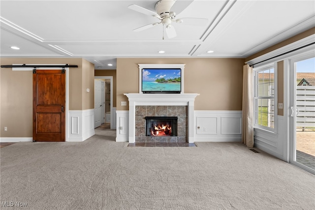 5215 River Rd, Madison, OH 44057 - unfurnished living room with carpet floors, recessed lighting, ceiling fan, a fireplace, and a barn door