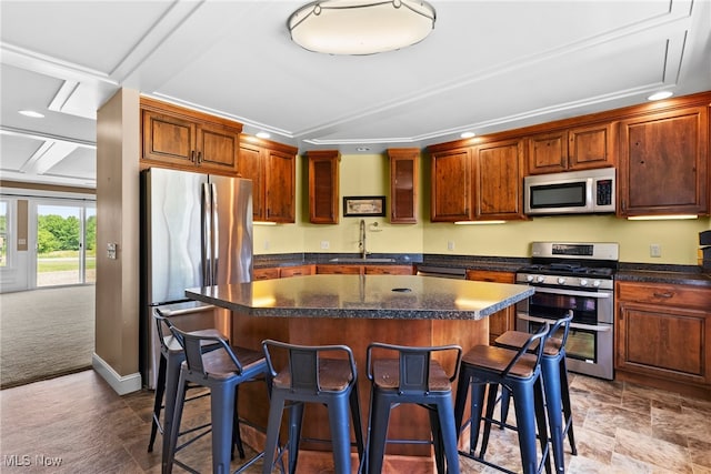 5215 River Rd, Madison, OH 44057 - kitchen featuring stainless steel appliances, a center island, a kitchen bar, dark countertops, and recessed lighting