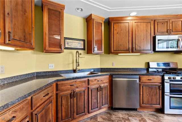 5215 River Rd, Madison, OH 44057 - kitchen featuring appliances with stainless steel finishes, dark countertops, brown cabinets, and recessed lighting