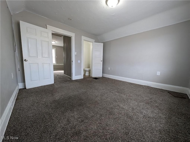 1268 E 169th St, Cleveland, OH 44110 - unfurnished bedroom with carpet flooring and lofted ceiling