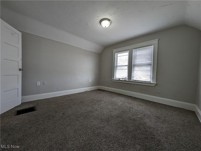 1268 E 169th St, Cleveland, OH 44110 - spare room with vaulted ceiling and carpet floors
