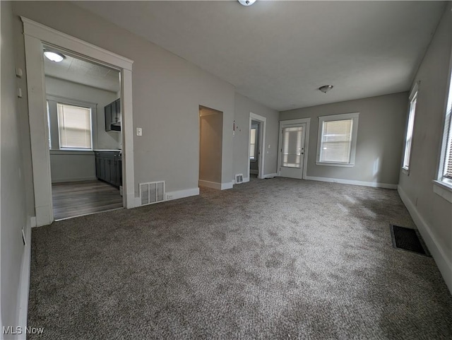 1268 E 169th St, Cleveland, OH 44110 - unfurnished living room with carpet flooring and healthy amount of natural light