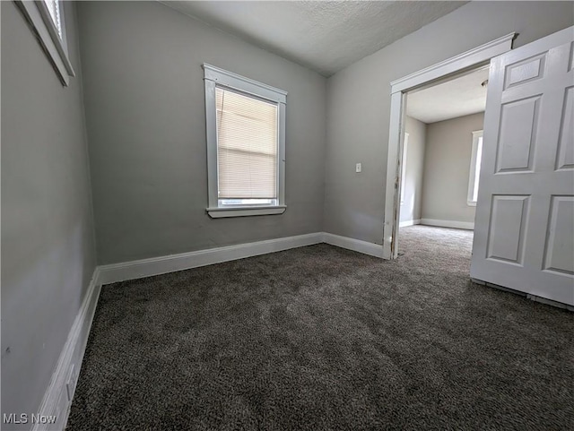 1268 E 169th St, Cleveland, OH 44110 - unfurnished room with dark carpet and plenty of natural light