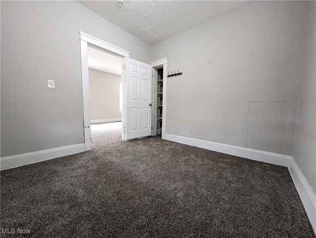 1268 E 169th St, Cleveland, OH 44110 - spare room with dark carpet and a textured ceiling