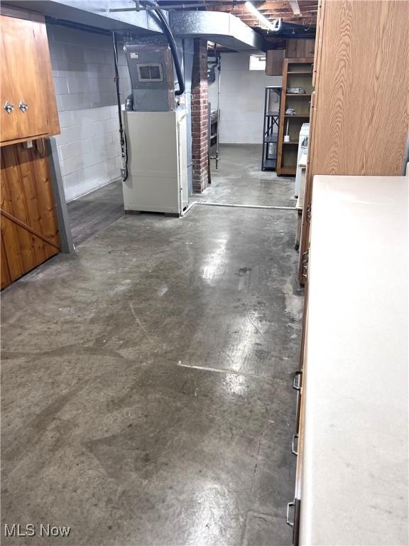 1760 Glenmount Ave, Akron, OH 44301 - unfinished below grade area featuring heating unit and concrete block wall