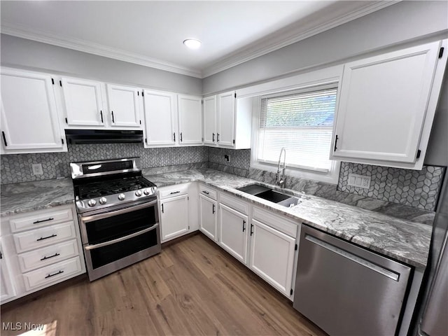 1760 Glenmount Ave, Akron, OH 44301 - kitchen featuring stainless steel appliances, ventilation hood, white cabinets, ornamental molding, and recessed lighting