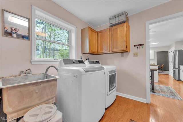 820 Old Spring Rd, Copley, OH 44321 - laundry room featuring cabinet space, light wood-style flooring, and washer and clothes dryer