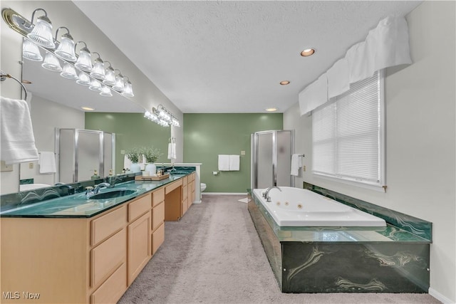 820 Old Spring Rd, Copley, OH 44321 - bathroom with a stall shower, double vanity, a tub with jets, recessed lighting, and a textured ceiling