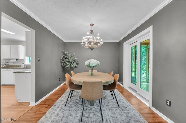 820 Old Spring Rd, Copley, OH 44321 - dining space featuring light wood-style flooring, ornamental molding, a chandelier, and a textured ceiling