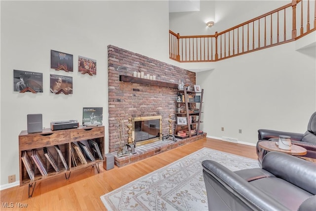 820 Old Spring Rd, Copley, OH 44321 - living area featuring a high ceiling, wood finished floors, and a fireplace