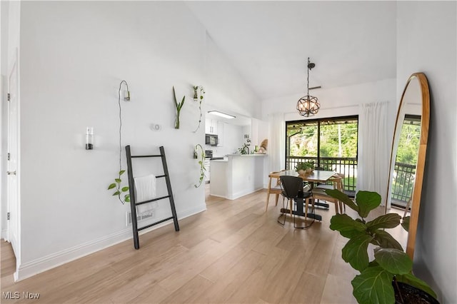 3800 Rosemont Blvd Unit 114C, Akron, OH 44333 - dining area featuring light wood finished floors, high vaulted ceiling, and a chandelier