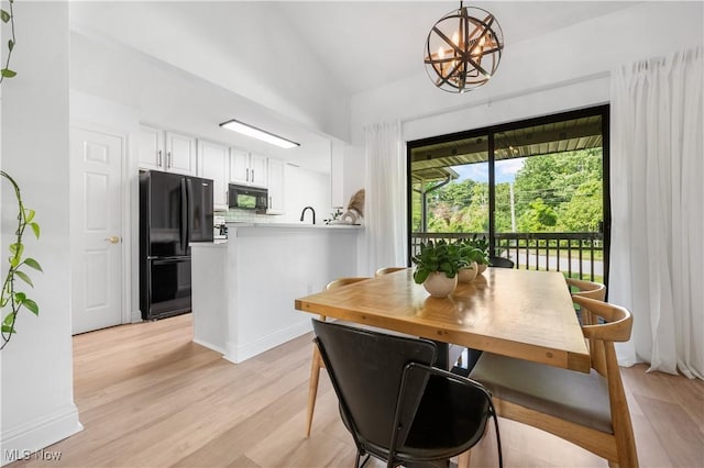 3800 Rosemont Blvd Unit 114C, Akron, OH 44333 - dining space featuring light wood-style floors, vaulted ceiling, and a chandelier