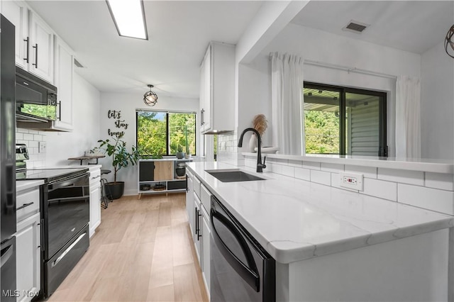 3800 Rosemont Blvd Unit 114C, Akron, OH 44333 - kitchen featuring black appliances, healthy amount of natural light, and white cabinetry