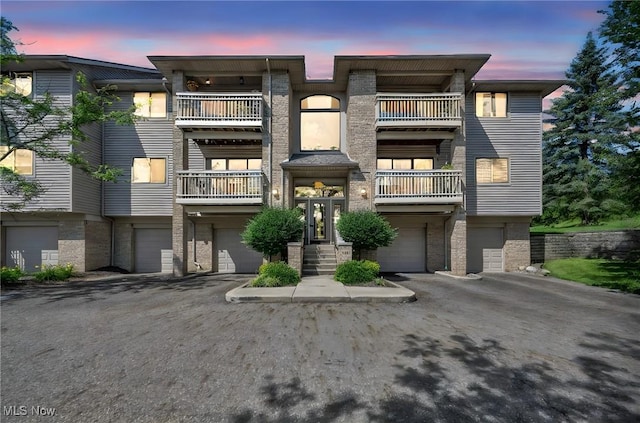 3800 Rosemont Blvd Unit 114C, Akron, OH 44333 - view of front of house with a garage, a balcony, driveway, and brick siding