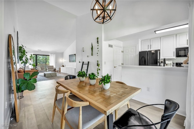 3800 Rosemont Blvd Unit 114C, Akron, OH 44333 - dining space with a chandelier, light wood finished floors, and high vaulted ceiling