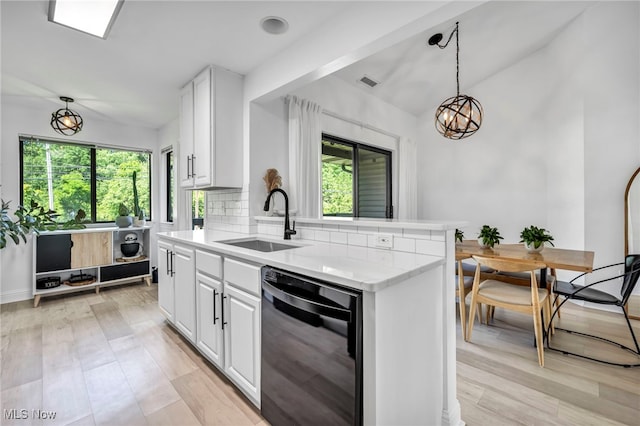 3800 Rosemont Blvd Unit 114C, Akron, OH 44333 - kitchen with black dishwasher, white cabinetry, decorative backsplash, decorative light fixtures, and lofted ceiling