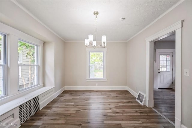 1206 Middle Ave, Elyria, OH 44035 - empty room with healthy amount of natural light, wood finished floors, a chandelier, and crown molding