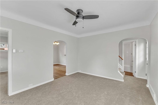 259 Marion Dr, Bedford, OH 44146 - carpeted spare room featuring arched walkways, ceiling fan, and stairs