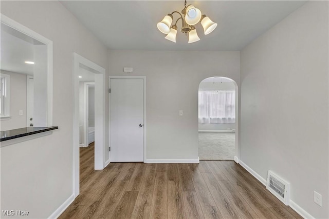 259 Marion Dr, Bedford, OH 44146 - unfurnished dining area with a chandelier and wood finished floors