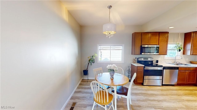 409 W Grant St, Kent, OH 44240 - kitchen with appliances with stainless steel finishes, light countertops, light wood-style flooring, plenty of natural light, and recessed lighting