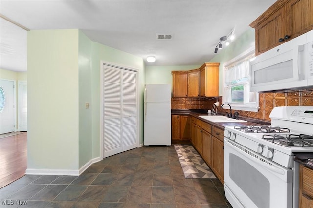 293 W 14th St, Salem, OH 44460 - kitchen with white appliances, tasteful backsplash, brown cabinetry, and dark countertops