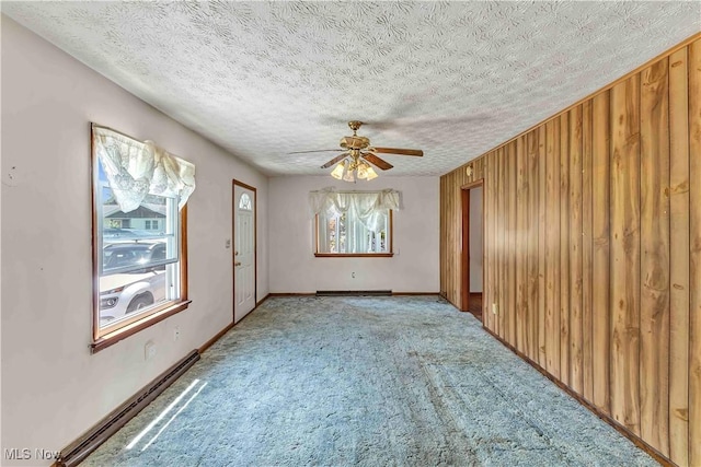 321 Overlook Rd, Vermilion, OH 44089 - carpeted spare room featuring a ceiling fan, a textured ceiling, and wooden walls