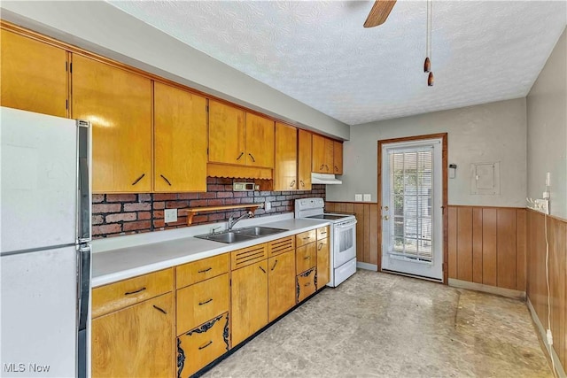 321 Overlook Rd, Vermilion, OH 44089 - kitchen featuring white appliances, a wainscoted wall, a textured ceiling, light countertops, and under cabinet range hood