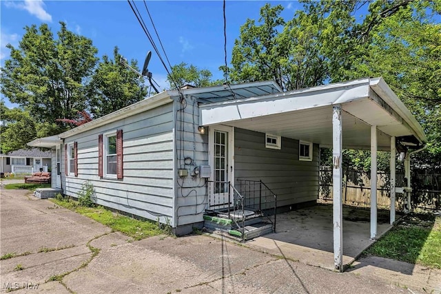 321 Overlook Rd, Vermilion, OH 44089 - view of side of home featuring concrete driveway and a carport