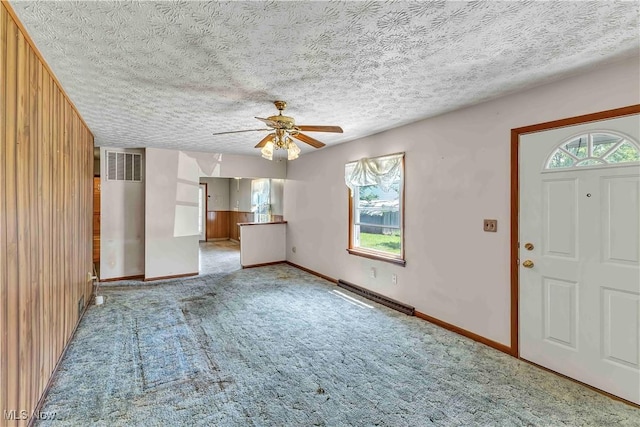 321 Overlook Rd, Vermilion, OH 44089 - carpeted foyer with a ceiling fan, a textured ceiling, and wooden walls