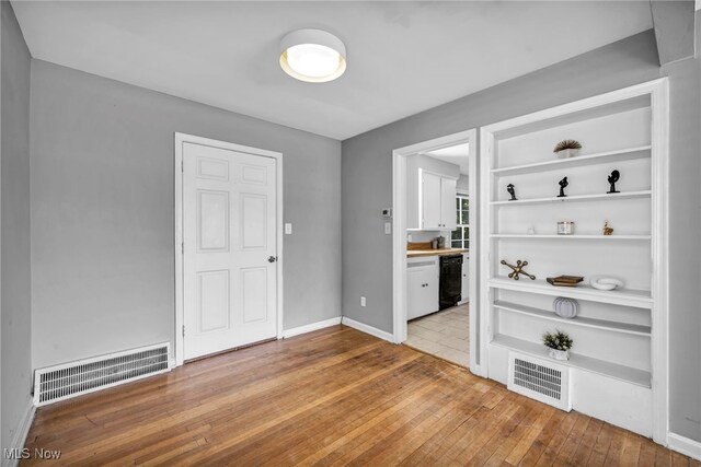 1159 S Belvoir Blvd, South Euclid, OH 44121 - spare room featuring wood-type flooring and baseboards