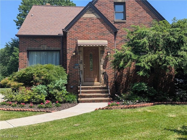 1975 E 226th St, Euclid, OH 44117 - tudor-style house with a front yard and brick siding