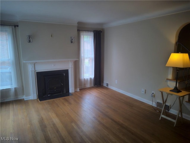 1975 E 226th St, Euclid, OH 44117 - unfurnished living room with ornamental molding, wood finished floors, and a fireplace with flush hearth