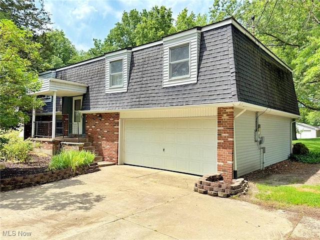 10511 Darrow Rd, Vermilion, OH 44089 - view of front of home with mansard roof, roof with shingles, brick siding, and concrete driveway