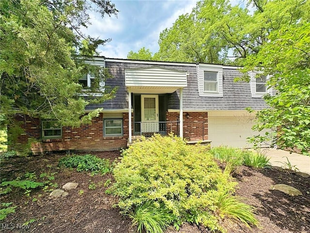 10511 Darrow Rd, Vermilion, OH 44089 - view of front of property featuring mansard roof, brick siding, an attached garage, and roof with shingles