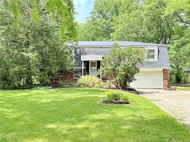 10511 Darrow Rd, Vermilion, OH 44089 - view of front of home with a garage, concrete driveway, brick siding, and a front lawn