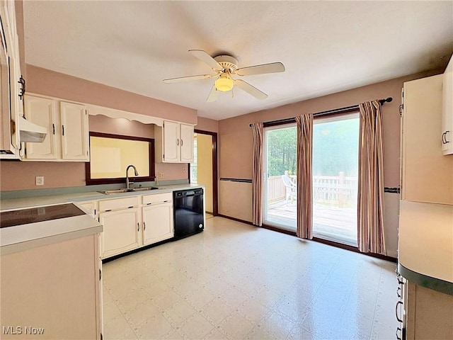 10511 Darrow Rd, Vermilion, OH 44089 - kitchen with black dishwasher, ceiling fan, light floors, under cabinet range hood, and white cabinetry