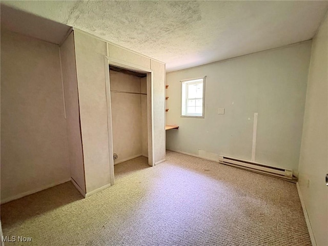 10511 Darrow Rd, Vermilion, OH 44089 - unfurnished bedroom featuring a baseboard heating unit, carpet, a closet, and a textured ceiling