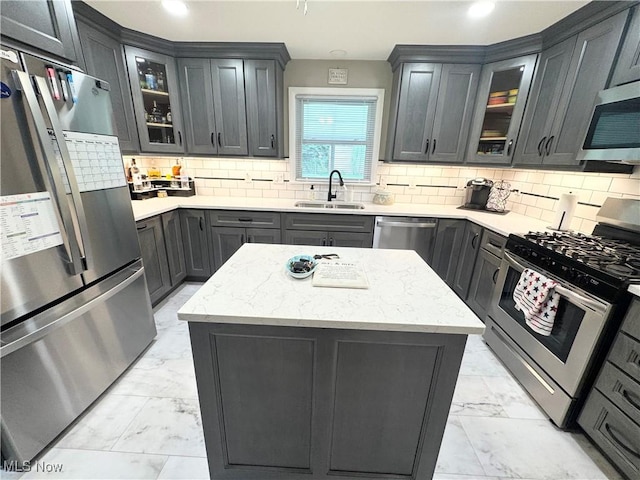 470 Geneva Ave, Struthers, OH 44471 - kitchen with stainless steel appliances, light marble finish flooring, a kitchen island, tasteful backsplash, and recessed lighting