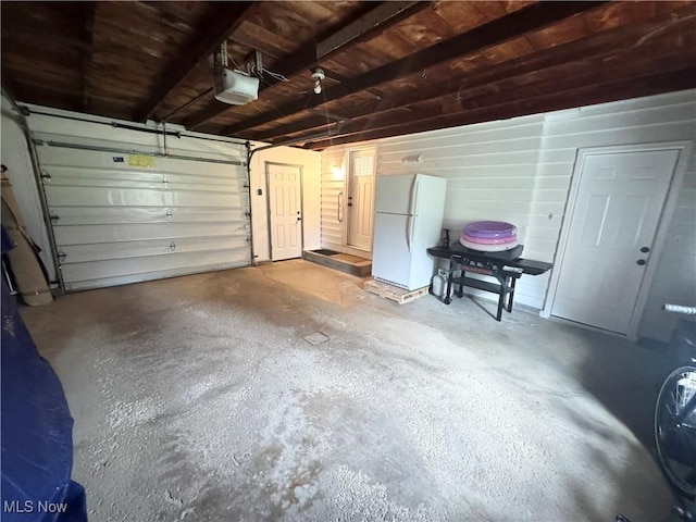 470 Geneva Ave, Struthers, OH 44471 - garage with freestanding refrigerator and a garage door opener