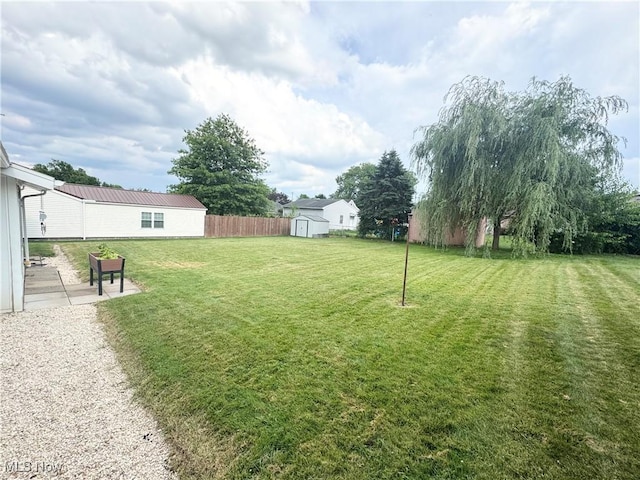 470 Geneva Ave, Struthers, OH 44471 - view of yard featuring a storage shed and a patio area