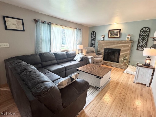 470 Geneva Ave, Struthers, OH 44471 - living room featuring a fireplace and light wood-style flooring